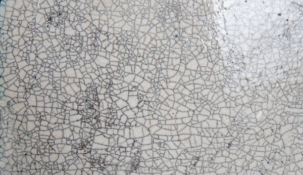 Un patrón de grieta en el esmalte de una placa de cerámica . —  Fotos de Stock