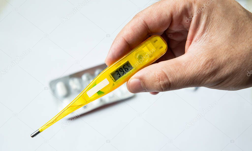 Closeup of Digital thermometer in the hand