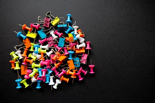 Siyah arkaplanda iğne ve kırtasiye malzemeleri, yakın plan