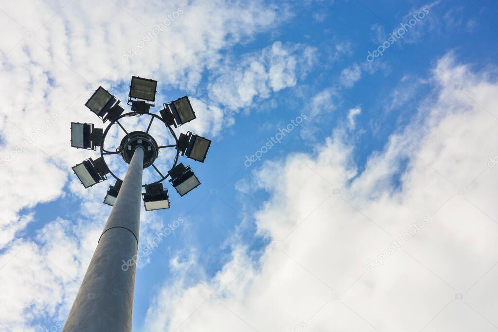 sport light post (street lamp pole) with cloud and blue sky background