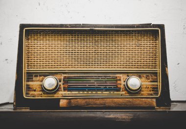 Eski ahşap ahşap radyo alıcısı ahşap masada beyaz grunge beton duvarlı arka plan, klasik efekt
