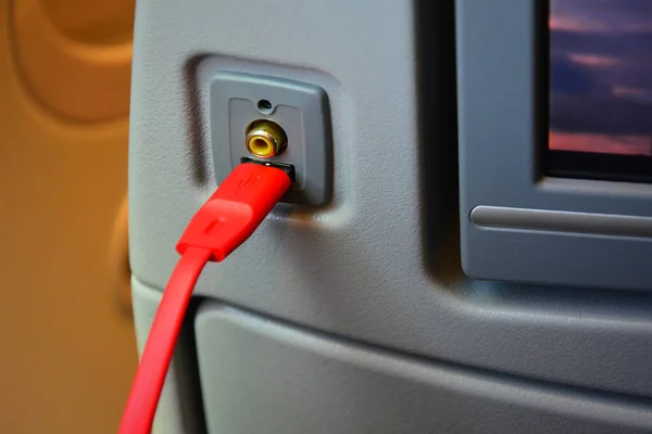 USB soket şarj cihazını ve uçak koltuğunun arkasındaki kırmızı USB kablosunu kapat.