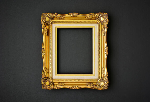 gold vintage picture frame on black color wall background, copy space, funeral and mourning concept