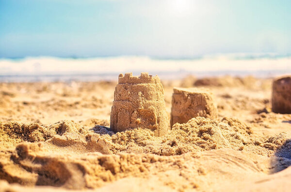 Children's bucket and sand figures made of sand on the beach by the sea