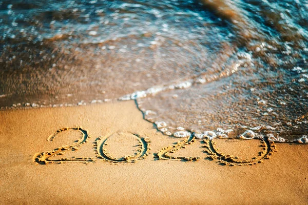 Happy new year 2021 text by the sea. Selective focus. Abstract background photography of the approaching New Year 2021 and the outgoing 2020