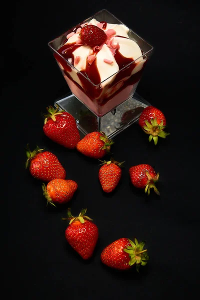 Strawberry dessert with strawberries on a black background, top view