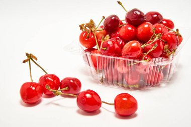 Beyaz arka planda taze kirazlı konteyner