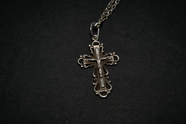 Cross with chain on a dark background