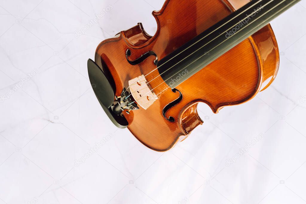 violin without bow on a white marble background. Selective focus.