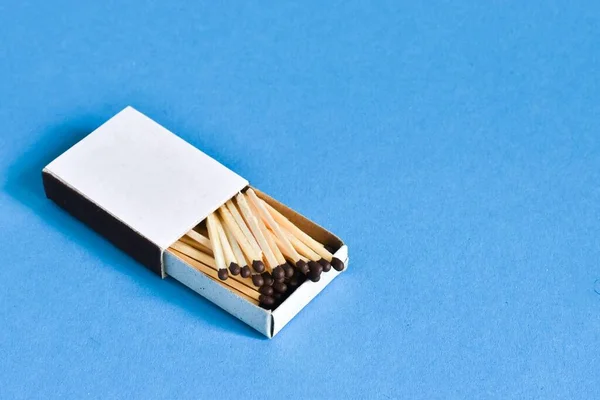 matches. box of matches on a blue isolated background. place for text
