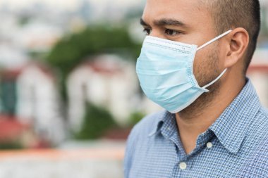 Korunaklı yüz maskesi takan Asyalı genç adamı Coronavirus 'a karşı kapatın..