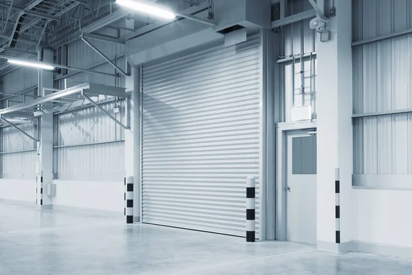 Roller shutter door and concrete floor inside factory building for industry background.
