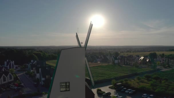 Huisje stad in de buitenwijken omgeven door eikenbos, grote decoratieve windmolen — Stockvideo