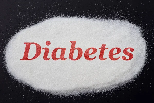 糖尿病という言葉は砂糖に赤で書かれた — ストック写真