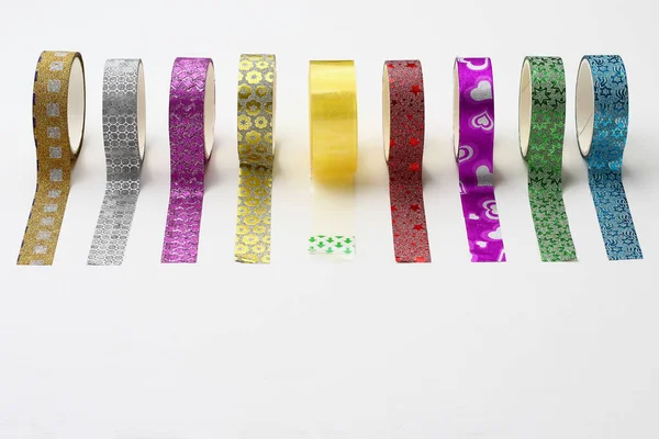 Rolls with scotch tape and decorative adhesive tapes for decorating gifts for the holidays. Background