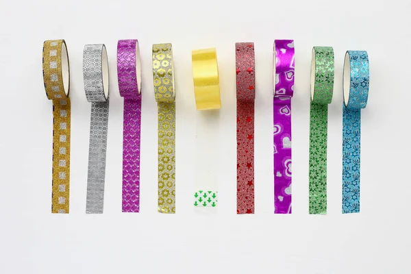 Rolls with scotch tape and decorative adhesive tapes for decorating gifts for the holidays. Background