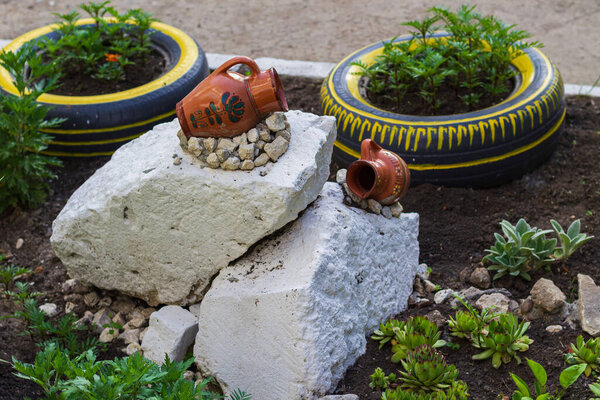 A common hobby of retirees is to make flower beds out of garbage. Background