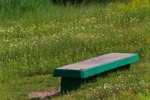 Concrete bench in the countryside outside the city. Nobody. Background