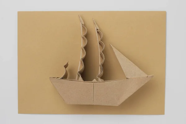 Origami paper sailboat mockup. Selective focus. Against the background of a classic mail envelope.