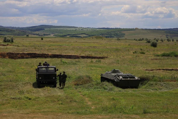 Armored personnel carrier infantry fighting vehicle. Military background with copyspace. Lots of heavy equipment.