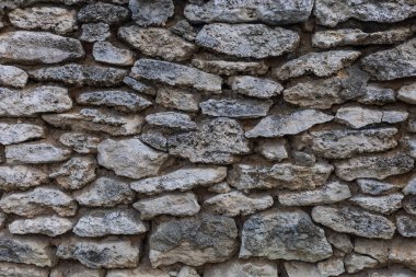 Vahşi taş duvarın kaba dokulu yüzeyi. Arkaplan