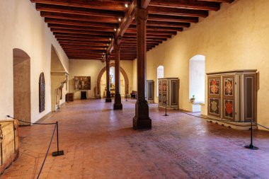 Ahşap tavanlı tarihi koridor ve antik binada süslü dolaplar. 19 Mart 2025, Karlstejn, Çek Cumhuriyeti.