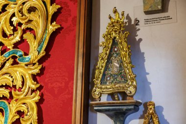 Barok altın süsü ve müzede sergilenen işlemeli bir eser. 20 Mart 2025, Cesky Krumlov, Çek.