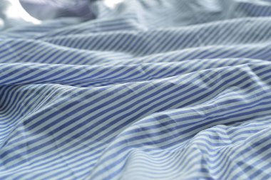 Çizgili kumaş. Pamuk, yatak örtüsü, kumaşta mavi ve beyaz çizgiler. Doku. Arkaplan.