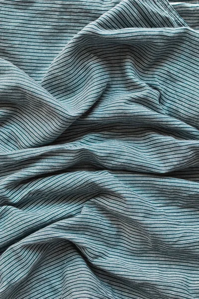 Striped fabric. Cotton, bedding, blue and white stripes on the fabric. Texture. Background.