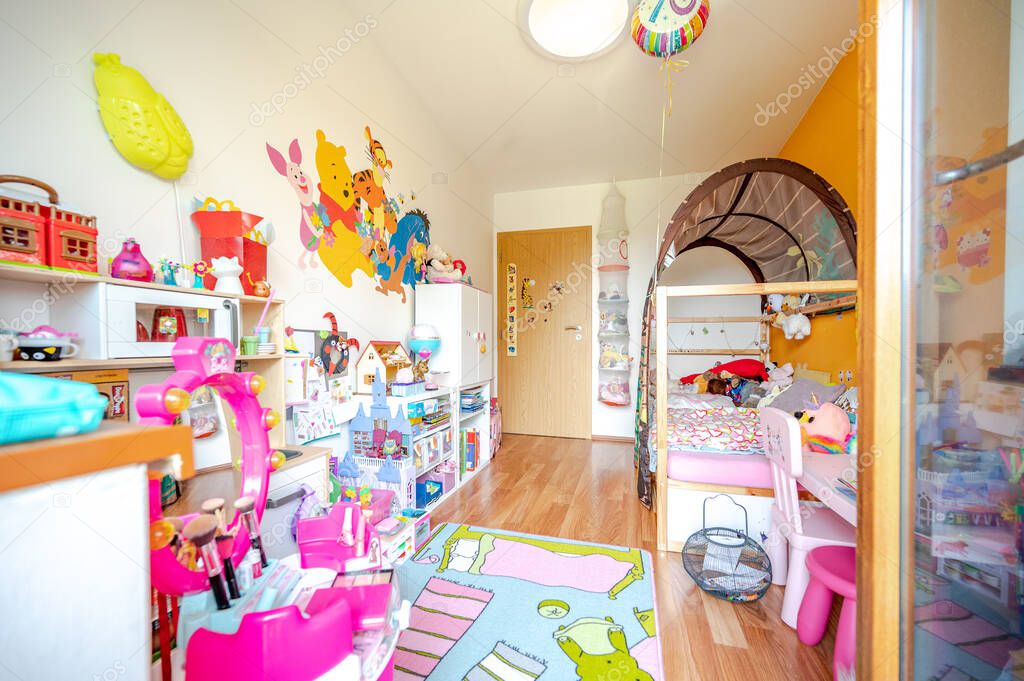 Kids room for little girl, full of toys.