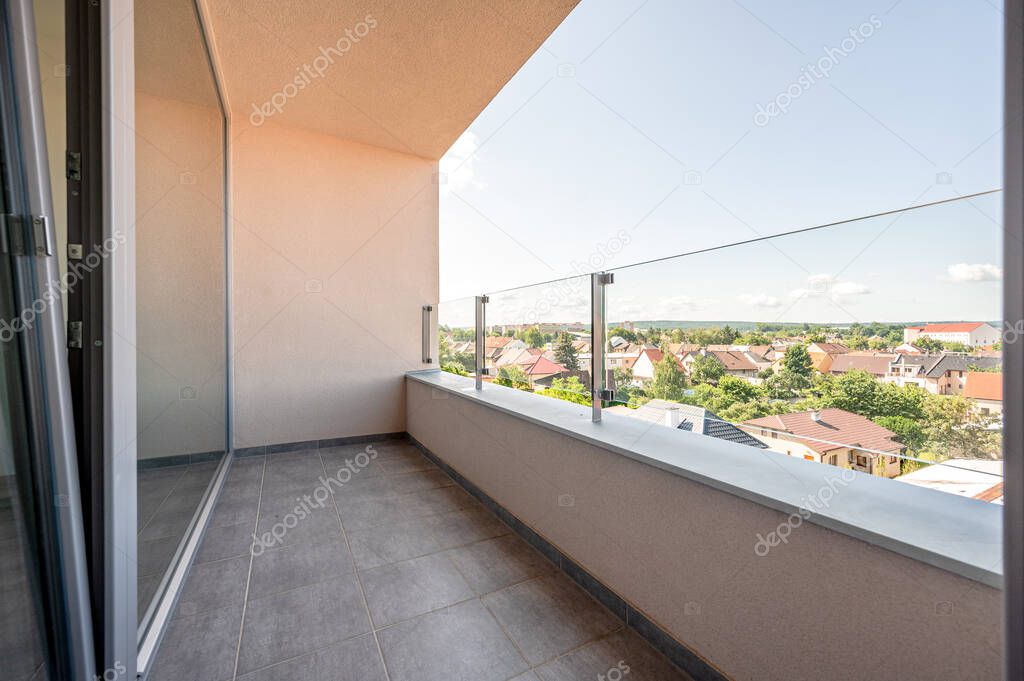 View from balcony, sunny day, clouds, wide angle real estate photo.