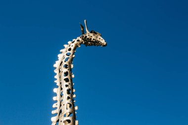Warsaw, Poland - March 18, 2020: Head of Metal Giraffe Sculpture in Praga Park in Warsaw clipart