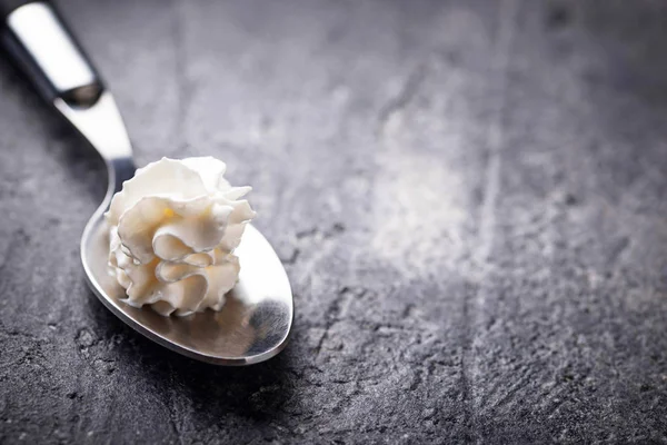 Whipped cream on a spoon — Stok Foto
