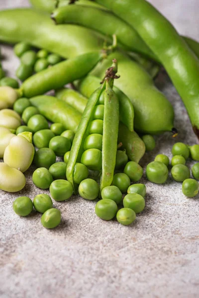 Fresh green peas and beans on light background — Stock Photo, Image
