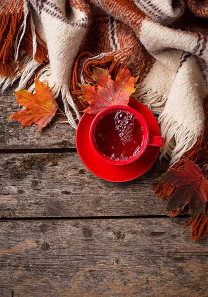 Autumn background with cup of tea, plaid and leaves — Stock Photo, Image