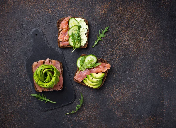 Healthy toasts with salmon and avocado rose — Stock Photo, Image