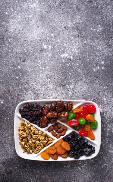Mix of dried fruits and nuts in plate — Stock Photo, Image