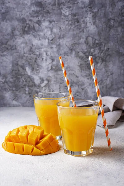 Fresh mango juice on light background