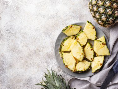 Plaka üzerinde dilimlenmiş olgun ananas