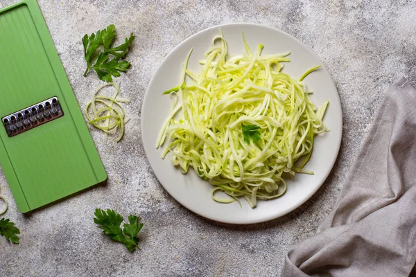 Raw green uncooked zucchini pasta