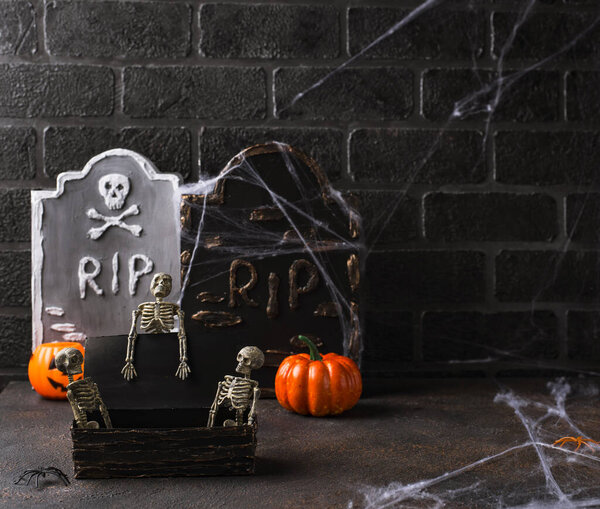 Halloween background with skeletons and tomb