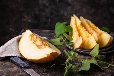 Taze taze olgun sulu dilimlenmiş kavun koyu arka planda