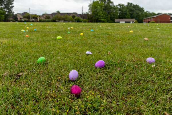 Close up of Easter eggs in grass field, with copy space for text