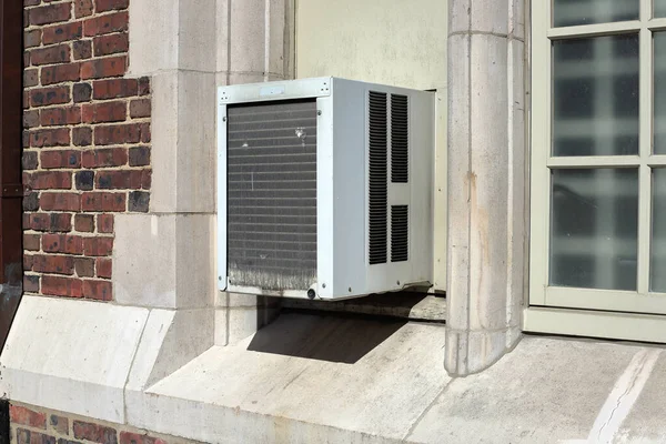 Window Air Conditioner unit on old brick building