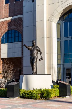 Tallahassee, FL / USA - February 15, 2020: Coach Bobby Bowden statue in front of Doak Campbell Stadium, home of Florida State University Football clipart