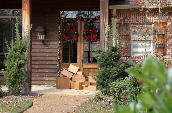 Boxes and packages next to front door during holiday christmas season.