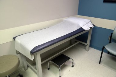 Medical Patient exam table in doctor's office clipart