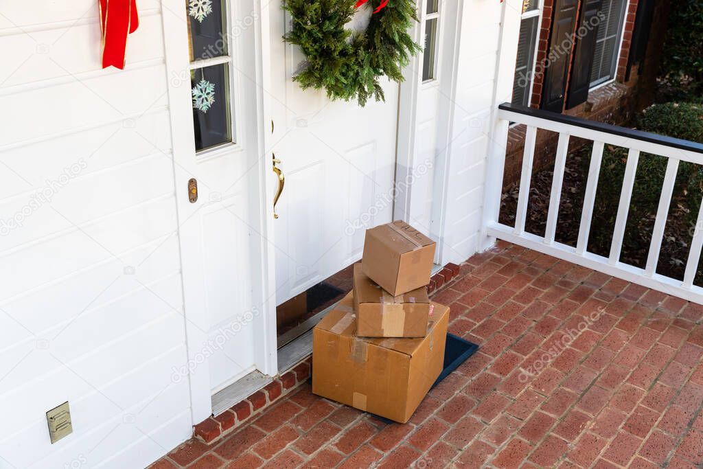 Packages on front porch of home during holiday season