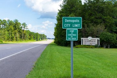 Demopolis, AL / USA: Demopolis City Limit yol tabelasının arkasında Demopolis Hoş Geldiniz tabelası, 80. karayolu boyunca.