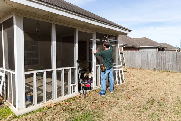 Homeowner Works Repairing Door Screened Back Porch — Stock Photo, Image